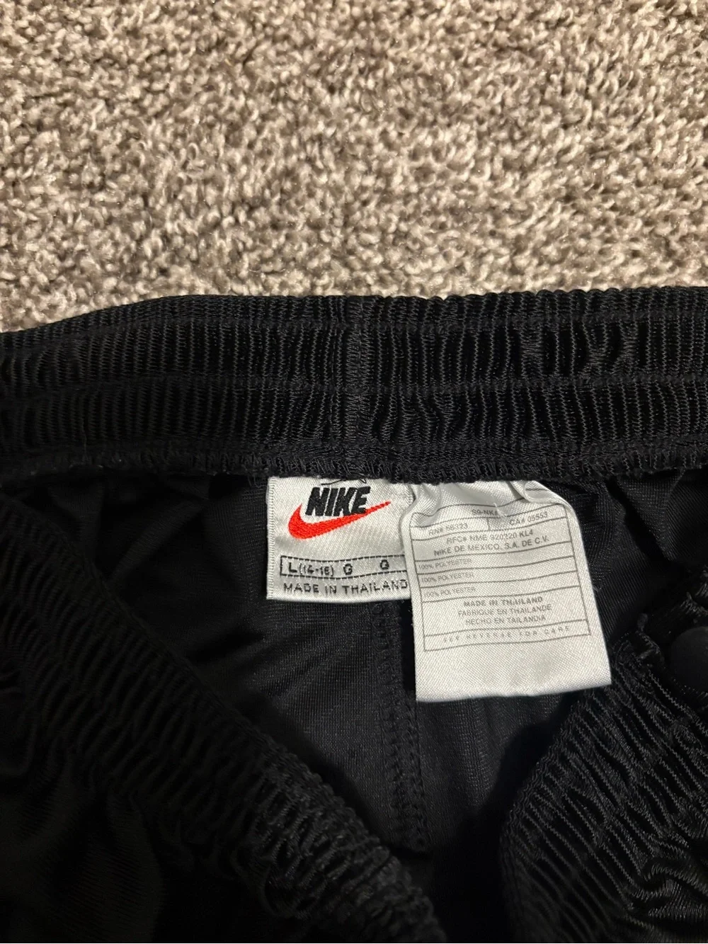 Vintage Nike Black Snap-Button Track Pants with White Swoosh
